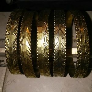 Five brass plated bangle bracelets